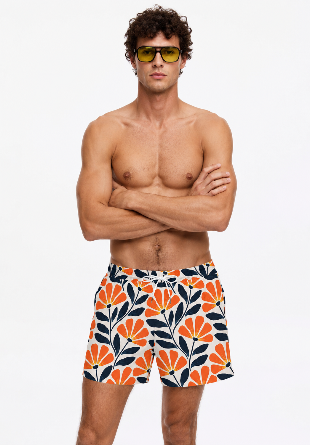 Man wearing colorful leaf-patterned swim shorts on a white background