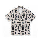Short-sleeve shirt with black abstract patterns on a beige background