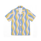 Short-sleeve shirt with blue and yellow wavy pattern on a white background
