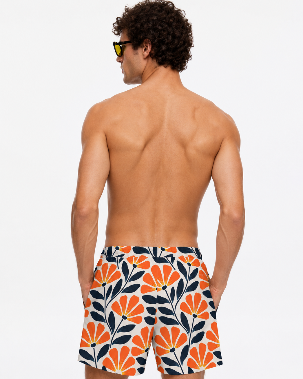Man wearing a colorful floral-patterned swimsuit on a white background