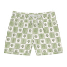 Green and white checkered shorts with tree pattern on a white background