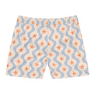 Swim shorts with starfish and wavy line pattern on a white background